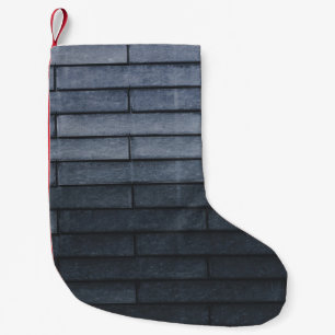 Close-up of gray brick wall small christmas stocking