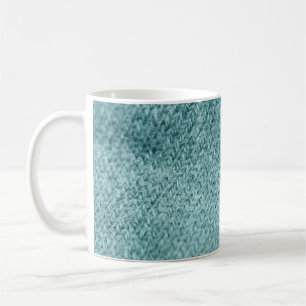 Close up of green knitted textured background. coffee mug