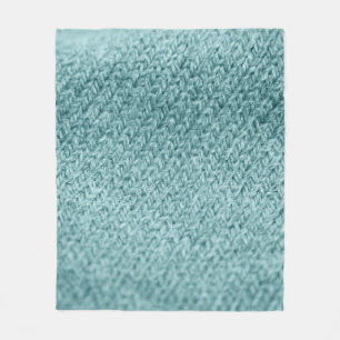 Close up of green knitted textured background.  fleece blanket