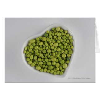 Close-up of green pebbles in a heart shape bowl