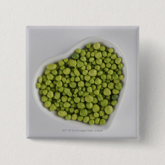 Close-up of green pebbles in a heart shape bowl 15 cm square badge