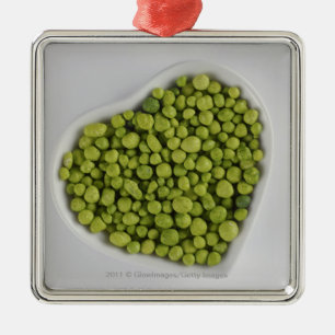 Close-up of green pebbles in a heart shape bowl metal tree decoration