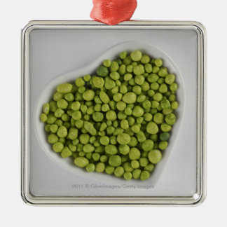 Close-up of green pebbles in a heart shape bowl metal tree decoration