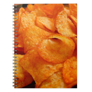Close up of juicy, crispy, chips on black plate. notebook