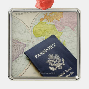 Close-up of passport lying on map metal tree decoration