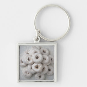 Close-up of powdered doughnuts in a plate key ring