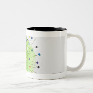 Close-up of straight pins inserted into a ball Two-Tone coffee mug