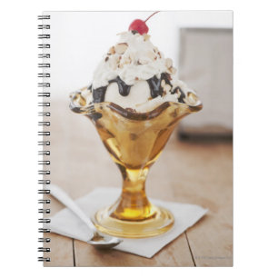 Close up of sundae with cherry on top notebook