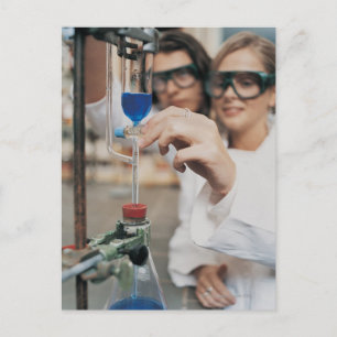 Close-up of Two University Students Adjusting Postcard