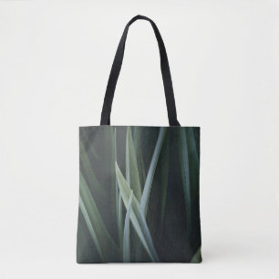 Close up photo of green linear leaves tote bag