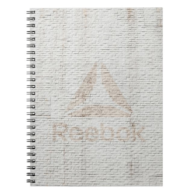 Close-up photo of Reebok logo on wall Notebook (Front)