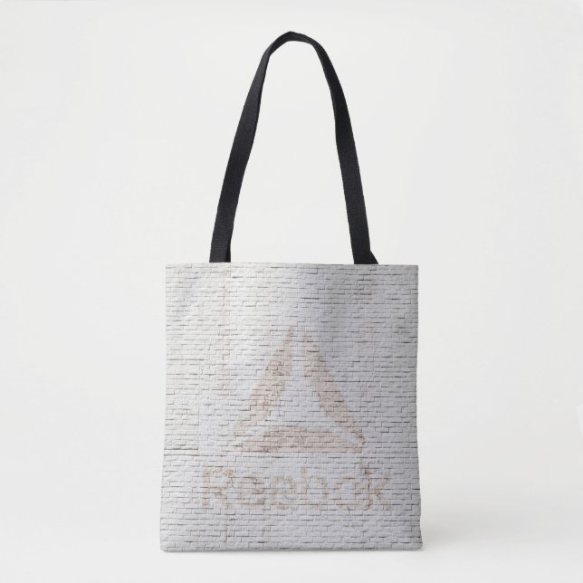 Close-up photo of Reebok logo on wall Tote Bag (Front)