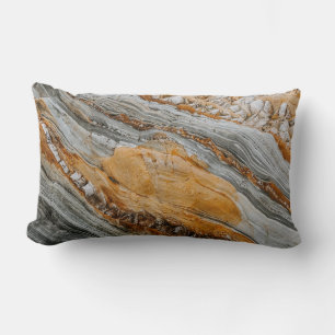 Close-up photography of grey and orange stones lumbar cushion