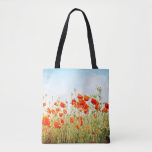 Close up poppies on field. Wild flowers in springt Tote Bag
