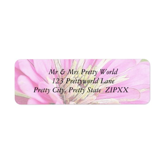 Close-up view of a delicate pink zinnia return address label