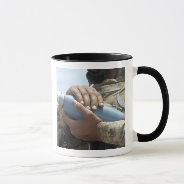 Close-up view of a soldier cradling a munition mug (Right)