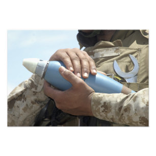 Close-up view of a soldier cradling a munition photo print