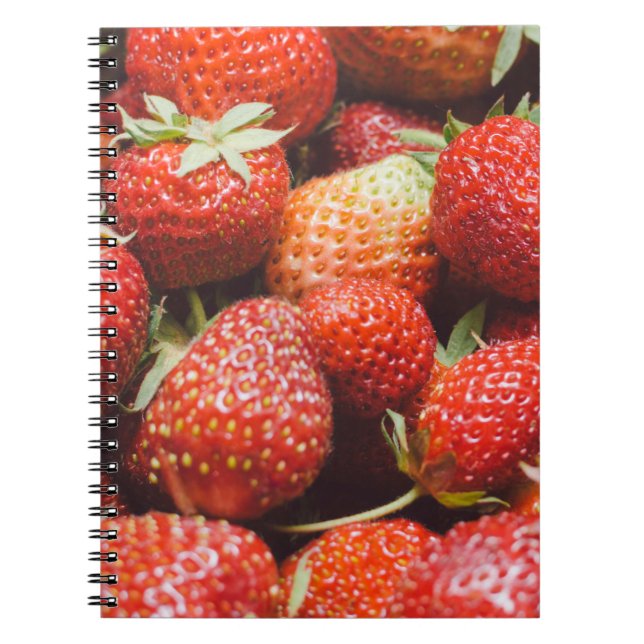 Close-up view on fresh summer strawberry with vint notebook (Front)
