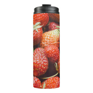 Close-up view on fresh summer strawberry with vint thermal tumbler