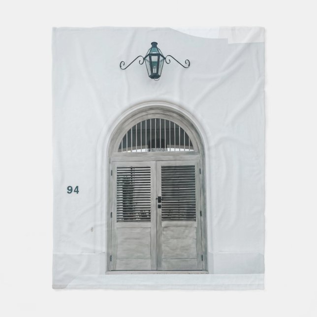 CLOSED GREY WOODEN DOOR BELOW BLACK LIGHT SCONCE FLEECE BLANKET (Front)