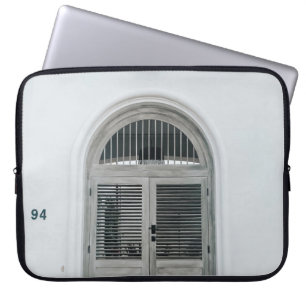 CLOSED GREY WOODEN DOOR BELOW BLACK LIGHT SCONCE LAPTOP SLEEVE