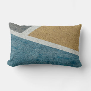 Closeup grey, yellow, and blue painted pavement lumbar cushion