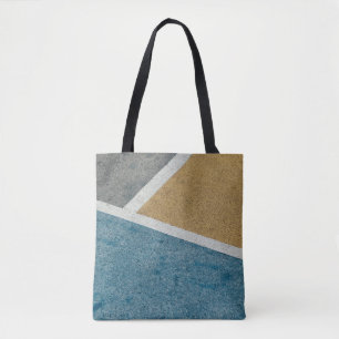 Closeup grey, yellow, and blue painted pavement tote bag