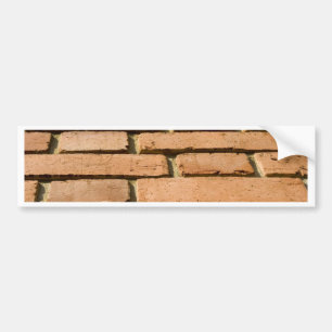 Closeup of a brick wall bumper sticker