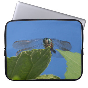 Closeup of a dragonfly against a bright blue sky laptop sleeve