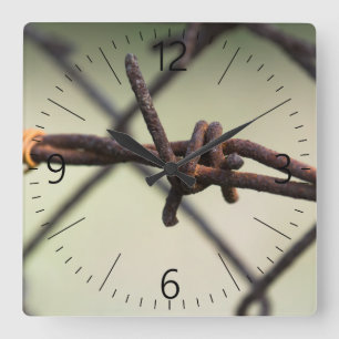 Closeup of barbed wire square wall clock