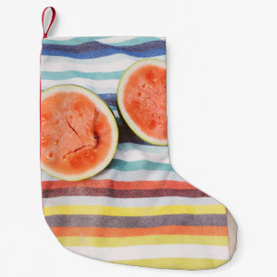 Closeup photo of slice watermelon fruits on cloth small christmas stocking