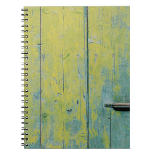 Closeup photo of yellow and teal wooden board notebook