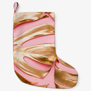 Closeup view of natural gold painted monstera trop small christmas stocking