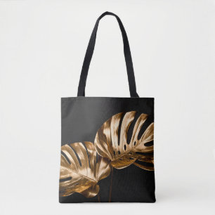 Closeup view of natural gold painted monstera trop tote bag