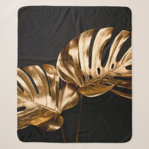 Closeup view of two luxurious golden painted tropi sherpa blanket