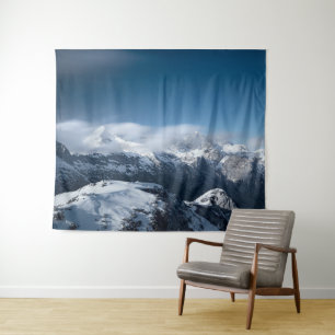 Clouds rolling above snowy mountains tapestry