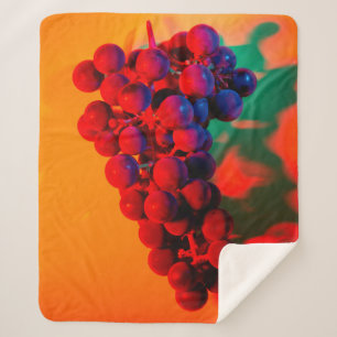 Cluster of blue grape in orange neon light. Food b Sherpa Blanket