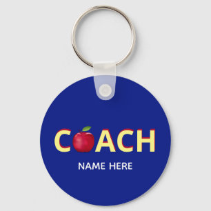 Coach text with red apple on blue key ring
