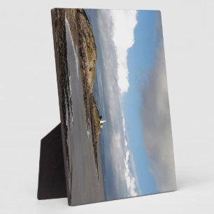 Coastal landscape and lighthouse plaque