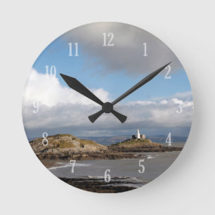 Coastal landscape and lighthouse round clock