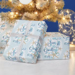 Coastal Tropical Christmas SEAsons Greetings Wrapping Paper<br><div class="desc">Wrap your Christmas holiday gifts in a tropical, coastal flair featuring SEAS & GREETINGS in an elegant calligraphy script typography design accented with starfish in turquoise aqua blue colours on an editable light blue background. ASSISTANCE: For help with design personalisation, transferring the design to another product or if you would...</div>