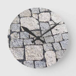 Cobblestones of a street in detail round clock