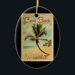 Cocoa Beach Palm Tree Vintage Travel Ceramic Ornament<br><div class="desc">A uniquely retro mid-century modern Cocoa Beach Florida art print in vintage travel poster style. It features a curved palm tree on sandy beach with ocean under a blue cloudy sky.</div>