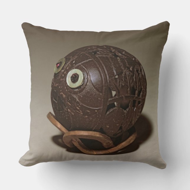 Coconut sculpted into a face, c.1895 cushion (Front)