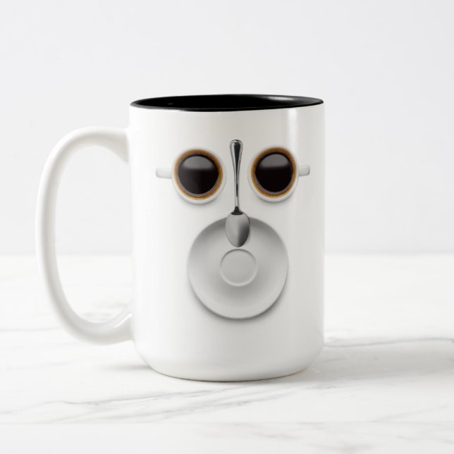 Coffee Face Two Cups of Coffee a Saucer and Spoon (Left)