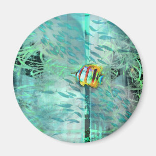 Collage angel fish swims in a school of blue fish magnet