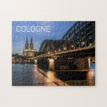 Cologne Cityscape Germany Dom Night Souvenir Jigsaw Puzzle<br><div class="desc">Cologne city with cathedral and Hohenzollern bridge in Germany night souvenir for North Rhine-Westphalia holiday. Cologne Dom Cityscape with Bridge and Panorama in Germany as a Souvenir for Cathedral City and Rhine. Cologne lifestyle for urban backpackers and Europe city trips. Cologne on the Rhine with Hohenzollern Bridge and Dom in...</div>