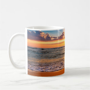 Colorful ocean beach sunrise with deep blue sky an coffee mug