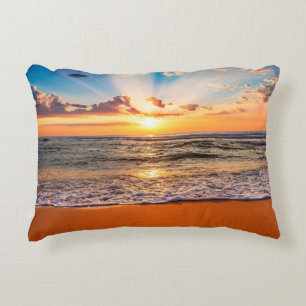 Colorful ocean beach sunrise with deep blue sky an decorative cushion