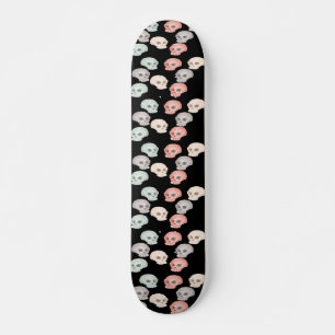 colorful skulls on black skateboard